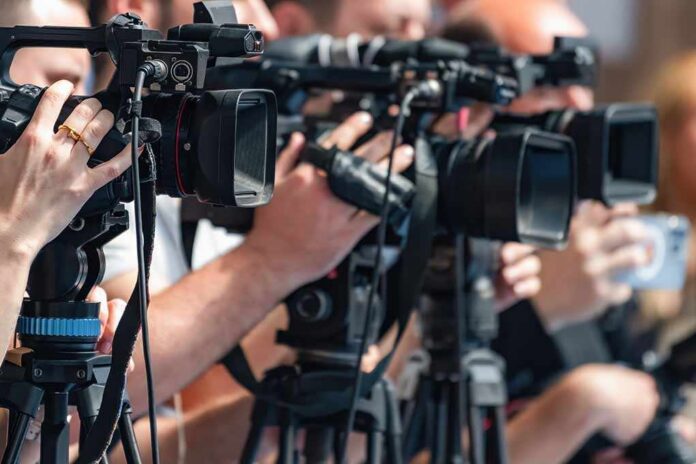 television cameras on tripods at a media event