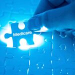 Hand placing a puzzle piece labeled Medicare