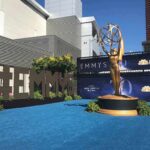 Emmy Awards outdoor setup with large statue and blue carpet