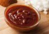 Bowl of thick barbecue sauce on a wooden surface