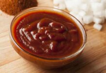 Bowl of thick barbecue sauce on a wooden surface