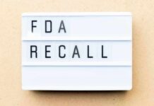 Lightbox sign reading FDA recall on beige background