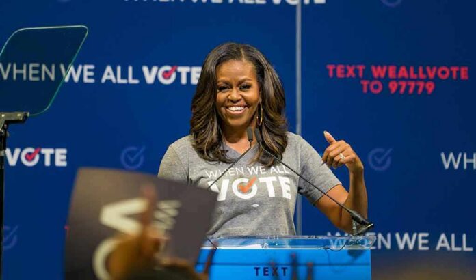 shutterstock_1329500510-5 woman speaking at a podium during a voting event