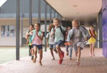 Group of schoolchildren running down a hallway