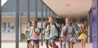 Group of schoolchildren running down a hallway
