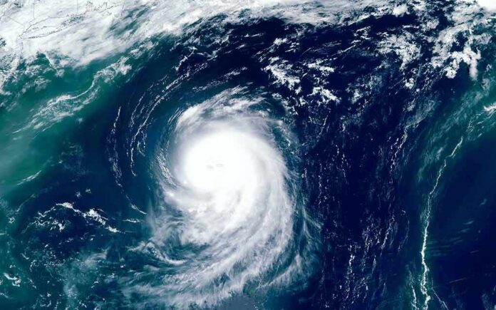 shutterstock_1493291597-2 Satellite view of a powerful hurricane swirling over the ocean