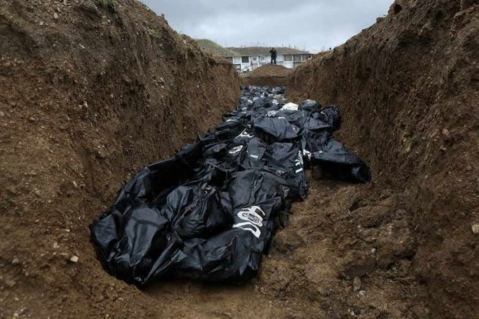 Body bags in a mass grave trench