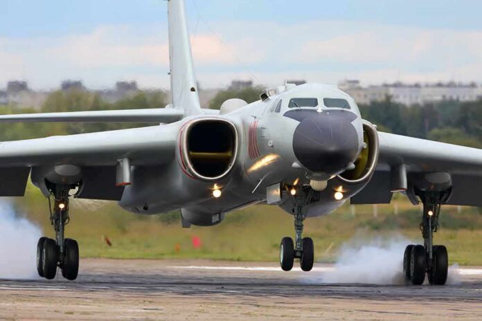 Military jet bomber landing on runway
