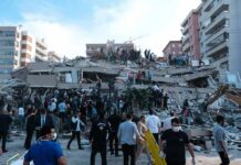 Rescue workers and civilians on collapsed building after earthquake