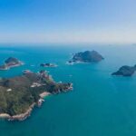 Aerial view of small green islands in a calm blue sea