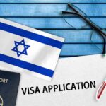 UK Tightens Pressure On Israeli Settlements Israeli flag beside passport and visa application form