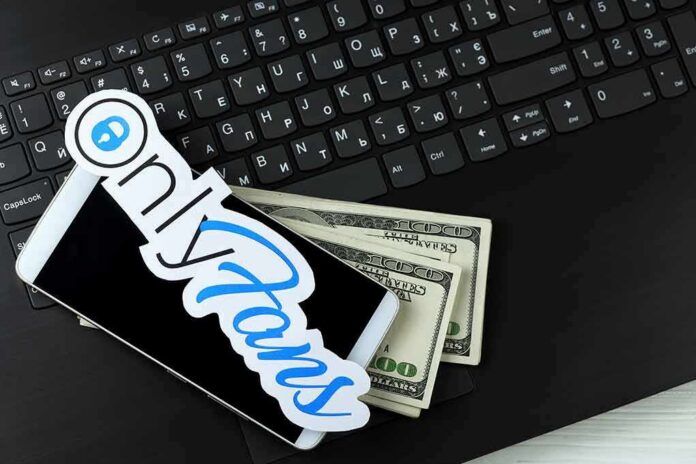 Smartphone with OnlyFans sticker and cash on a laptop keyboard