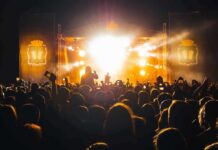 Stadium Veto Silences Macklemore Crowd at a nighttime concert with bright stage lights