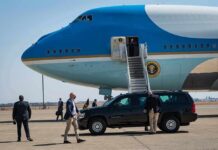 Middle East Flashpoint Triggers Trump Dash Security detail near blue and white aircraft with staircase and SUV