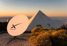Starlink satellite dish near a pyramid-shaped building at sunset