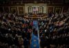 Legislative chamber audience stands and applauds