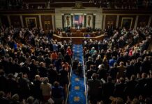 Legislative chamber audience stands and applauds