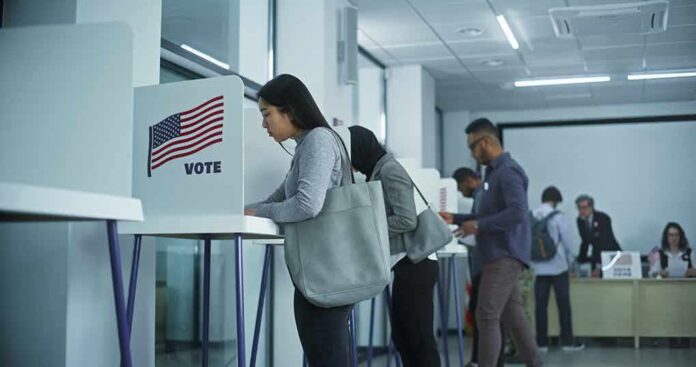 Voters at polling booths in a modern voting center