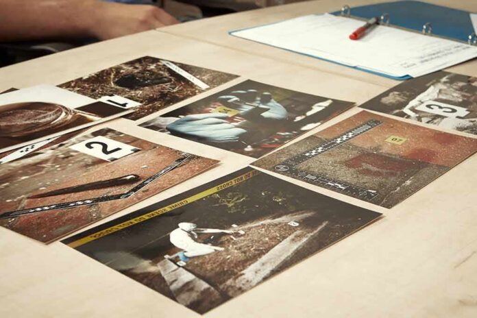 Crime scene photos laid out on a desk