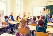 California Teacher Sex Cases End in Pleas Students raise hands in a classroom with a teacher at the front