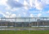 Prison yard behind chain-link and razor wire fence