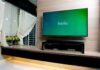 flat-screen TV on wood wall with streaming app open