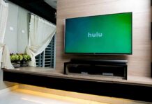 flat-screen TV on wood wall with streaming app open