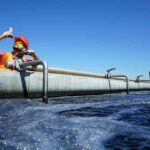 Engineer inspecting water sample at wastewater treatment plant