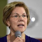 Elizabeth Warren speaking into a microphone