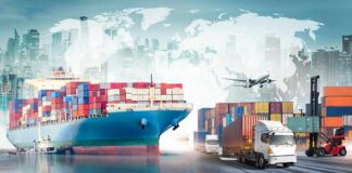 Cargo ship with containers alongside trucks, plane, and forklifts at a port