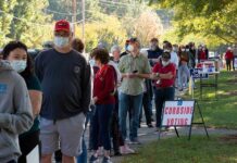 Christian Jones and others waiting in a long line outside a polling place