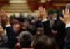 Council Chaos: Mayor Lunges At Critic Raised hands in a formal meeting or vote