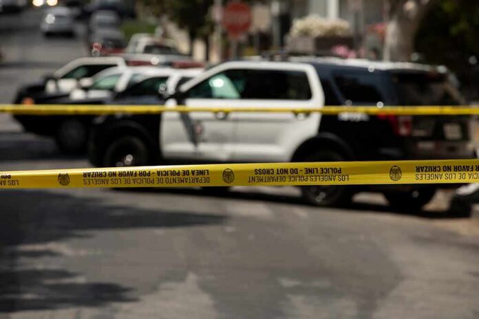 Police tape cordoning off street with patrol SUVs behind