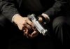 person holding a silver handgun