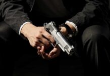 Toddler Gunshot Stuns Drive-Thru – Charges Loom? person holding a silver handgun