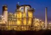 An industrial facility with illuminated structures at night