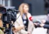 Video camera filming an outdoor media interview