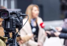 Video camera filming an outdoor media interview