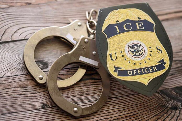 ICE officer badge and handcuffs on wooden surface