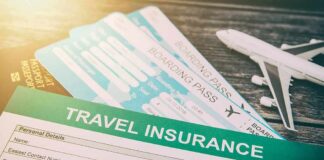 Travel insurance form with boarding passes and toy airplane