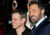 two men smiling at an event