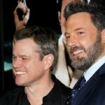 two men smiling at an event
