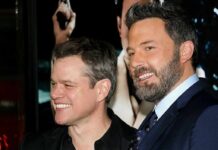 two men smiling at an event
