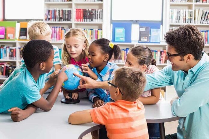 Children and teacher gathered around a small globe in a library