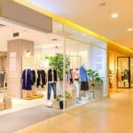 Clothing boutique in a shopping mall with mannequins and racks