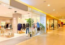 Clothing boutique in a shopping mall with mannequins and racks