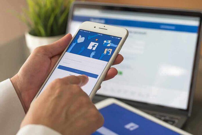 shutterstock_680847808 hands using a smartphone with a social media login screen