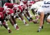 American football players lined up at the line of scrimmage