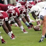 American football players lined up at the line of scrimmage