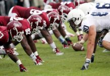 American football players lined up at the line of scrimmage